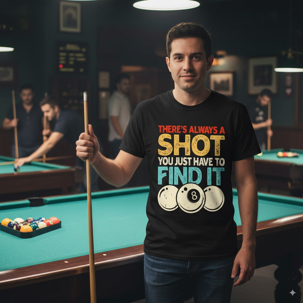 Man holding a pool cue in a billiards room wearing a t-shirt with a pool-themed design.